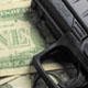 gun on top of money